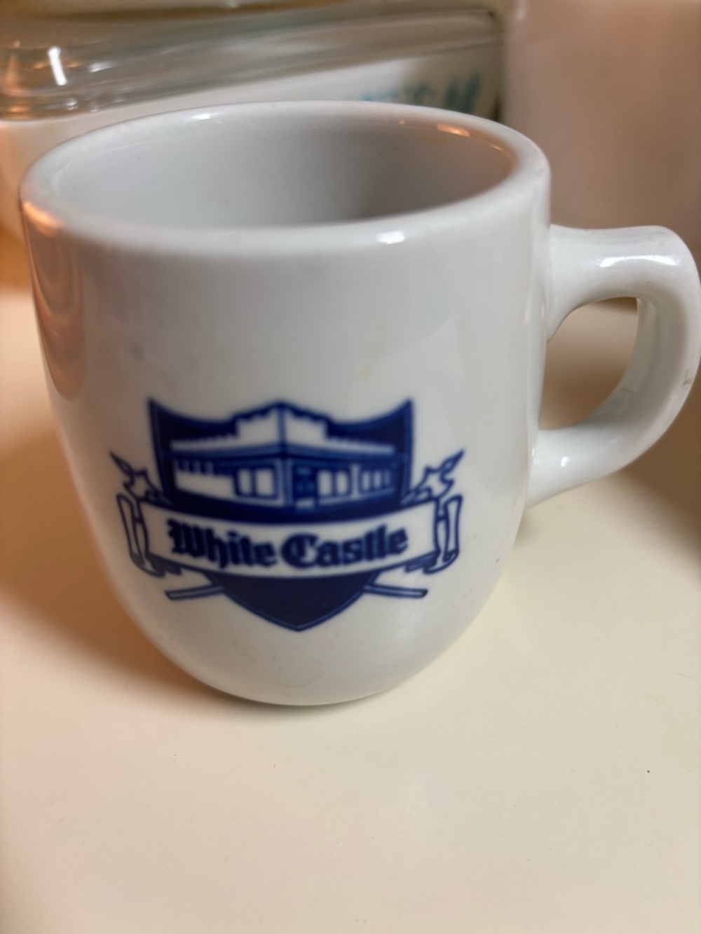 Branded White Ceramic Mug with Blue Logo